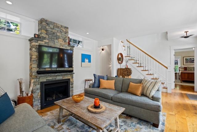29 Point St, Provincetown, MA 02657 - living area with wood-type flooring, stairway, and a stone fireplace
