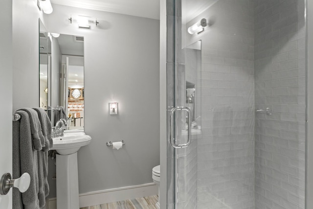 29 Point St, Provincetown, MA 02657 - bathroom with a shower stall, toilet, baseboards, and wood finished floors