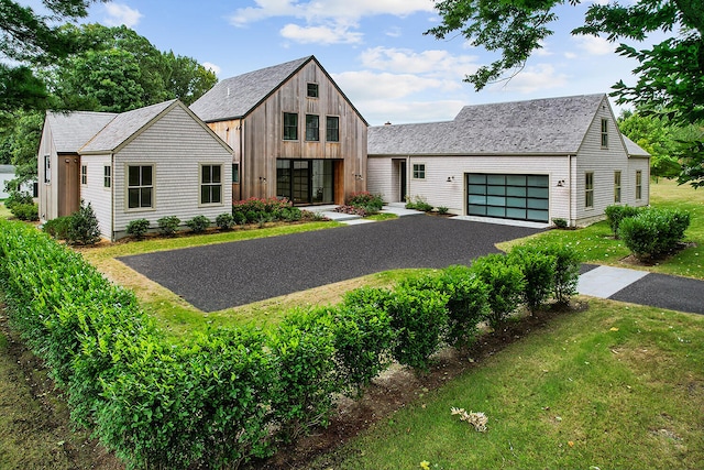 modern farmhouse style home with a garage and a front yard