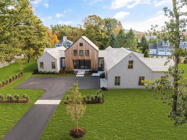 modern farmhouse style home with a front lawn