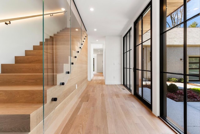 interior space with hardwood / wood-style floors and floor to ceiling windows