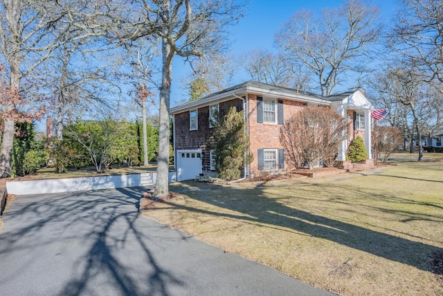 view of front of home with a front yard and a garage