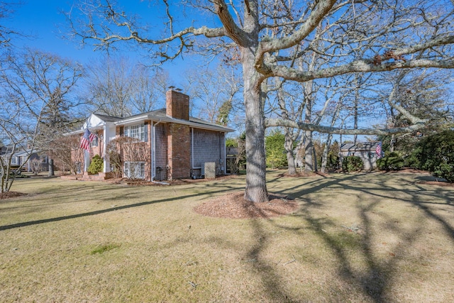 view of side of property featuring a yard