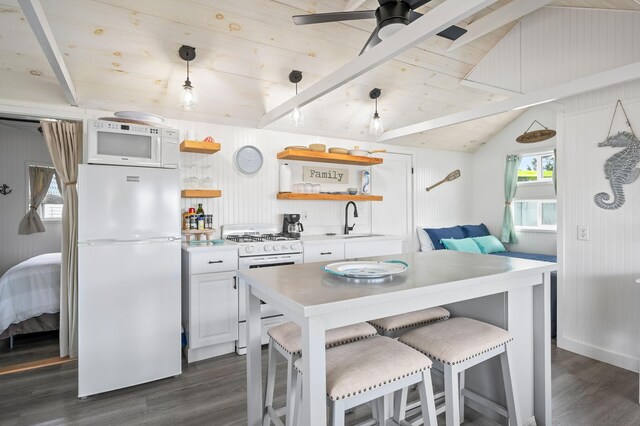 241 Old Wharf Rd Unit 90, Dennis Port, MA 02639 - kitchen with white appliances, open shelves, dark wood-style flooring, a sink, and a kitchen bar