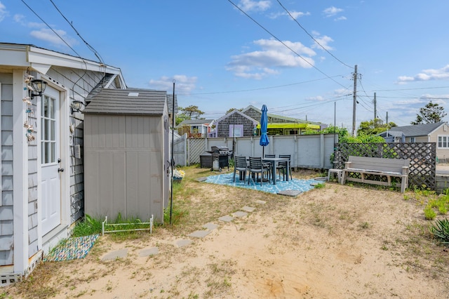 241 Old Wharf Rd Unit 90, Dennis Port, MA 02639 - view of yard with a storage shed, an outdoor structure, fence, and a patio area