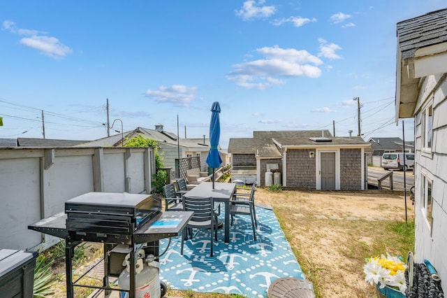 241 Old Wharf Rd Unit 90, Dennis Port, MA 02639 - view of patio featuring a fenced backyard, an outbuilding, a shed, and a grill
