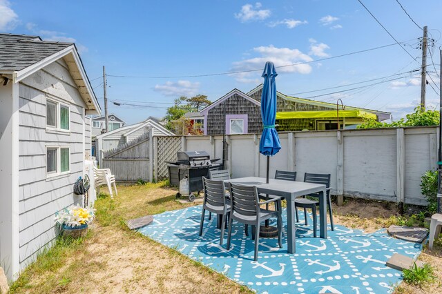241 Old Wharf Rd Unit 90, Dennis Port, MA 02639 - view of patio / terrace with a grill and a fenced backyard