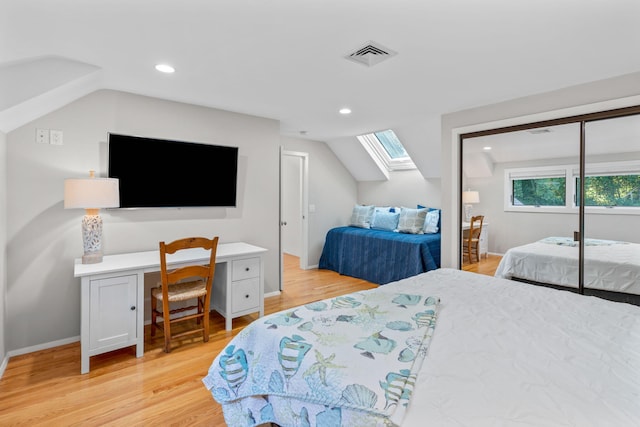 bedroom with vaulted ceiling and light hardwood / wood-style floors