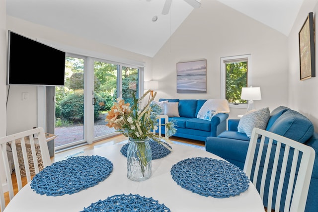 living room with vaulted ceiling, plenty of natural light, hardwood / wood-style floors, and ceiling fan