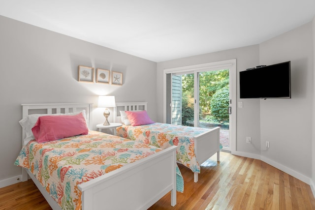 bedroom with light hardwood / wood-style flooring and access to outside