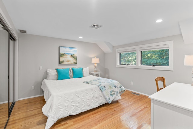 bedroom with light wood-type flooring and a closet