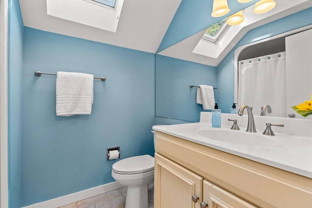 bathroom featuring tile patterned flooring, vanity, lofted ceiling with skylight, and toilet