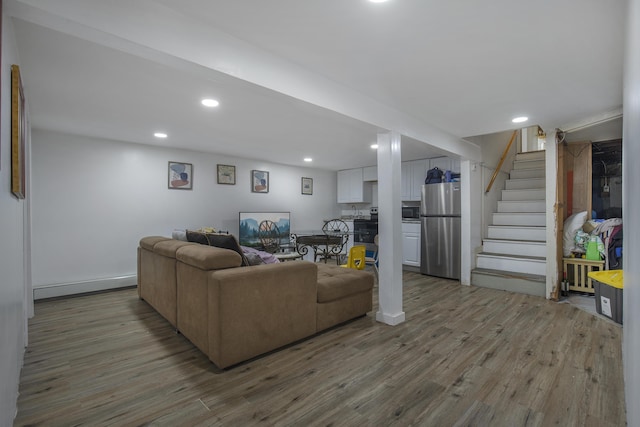 298 Oakland Rd, Hyannis, MA 02601 - living area featuring wood finished floors, stairs, recessed lighting, and a baseboard radiator
