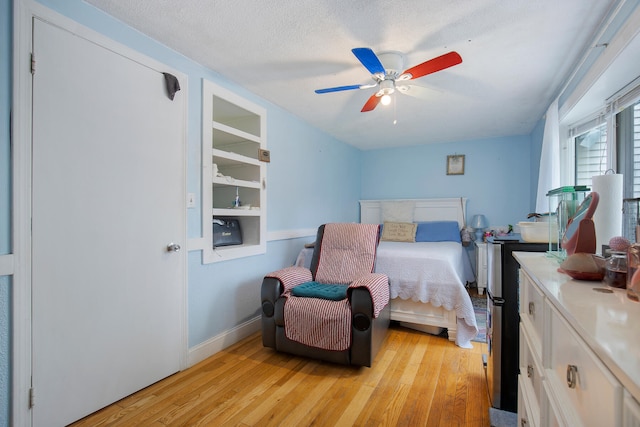 298 Oakland Rd, Hyannis, MA 02601 - bedroom with light wood finished floors, baseboards, ceiling fan, and a textured ceiling