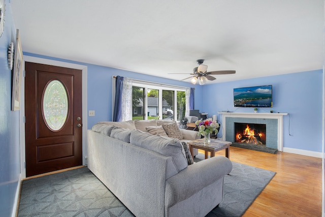 298 Oakland Rd, Hyannis, MA 02601 - living area featuring light wood-type flooring, a brick fireplace, a ceiling fan, and baseboards