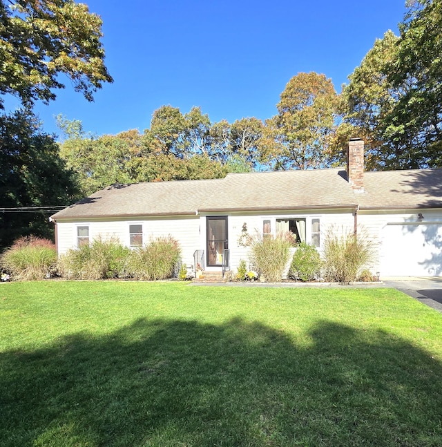 ranch-style home with a garage and a front yard