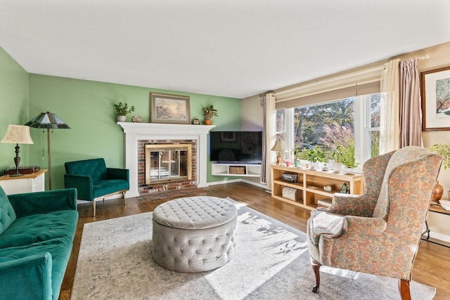 living room with a fireplace and wood-type flooring