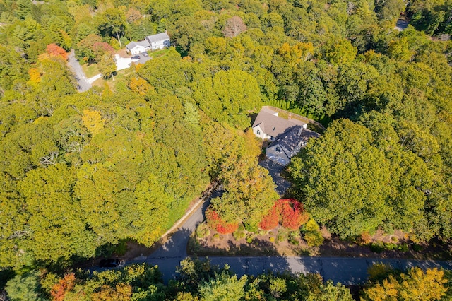 birds eye view of property featuring a view of trees