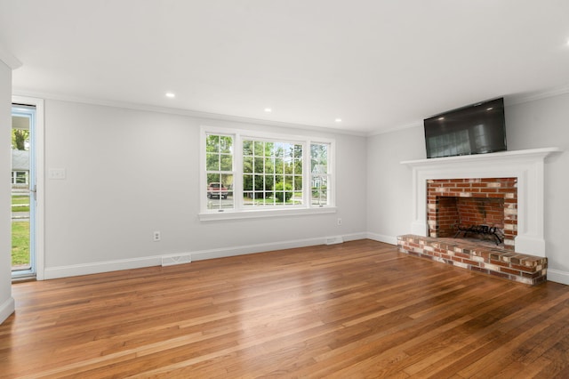 6 Harrington Way, Hyannis, MA 02601 - unfurnished living room with wood finished floors, ornamental molding, a fireplace, baseboards, and recessed lighting