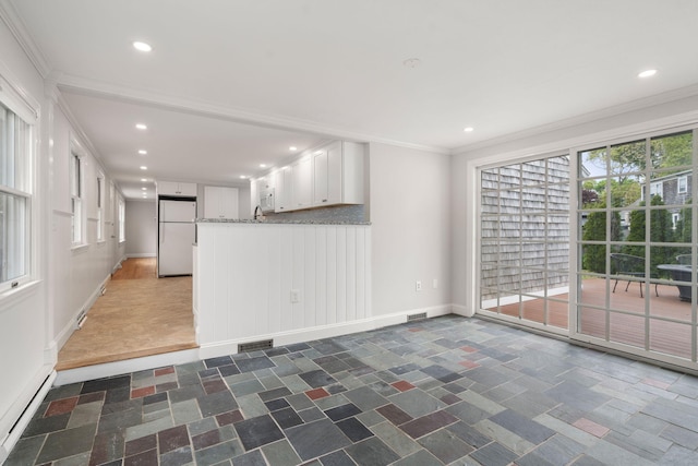 6 Harrington Way, Hyannis, MA 02601 - unfurnished living room featuring baseboard heating, baseboards, ornamental molding, recessed lighting, and dark stone finish floors