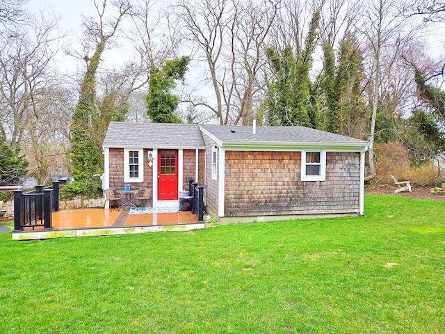24 Old Tote Rd, Orleans, MA 02653 - view of front facade with a deck and a front yard