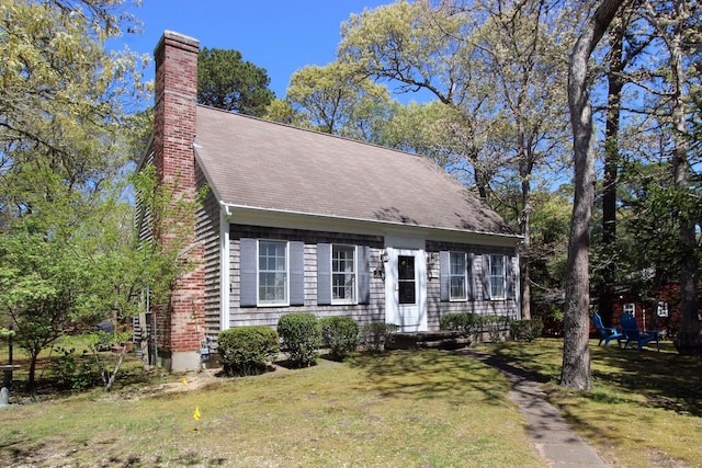 19 Featherbed Ln, Brewster, MA 02631 - cape cod house featuring a chimney, a front lawn, and a shingled roof