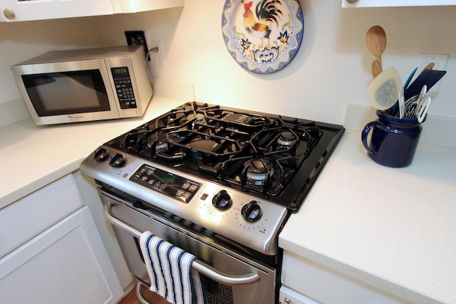 19 Featherbed Ln, Brewster, MA 02631 - kitchen view of stainless steel appliances, light countertops, and white cabinetry