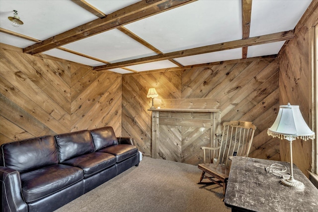 carpeted living room featuring beam ceiling and wood walls