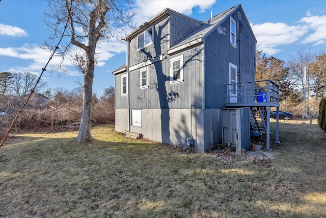 view of property exterior featuring a wooden deck and a lawn