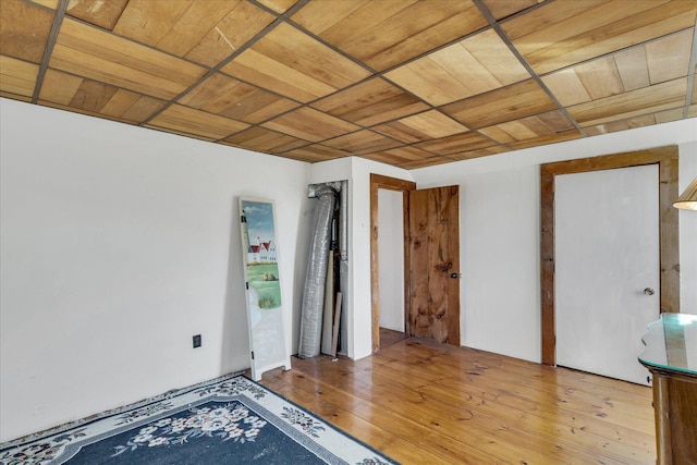 unfurnished room with hardwood / wood-style floors and wood ceiling