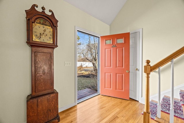 entrance foyer featuring lofted ceiling and light hardwood / wood-style flooring