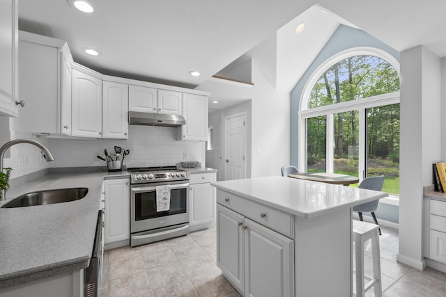 23 Walkerwoods Dr, Harwich, MA 02645 - kitchen featuring electric range, under cabinet range hood, tasteful backsplash, white cabinets, and a kitchen bar