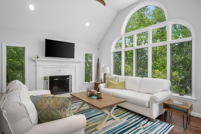 23 Walkerwoods Dr, Harwich, MA 02645 - living room featuring wood finished floors, lofted ceiling, a brick fireplace, and recessed lighting