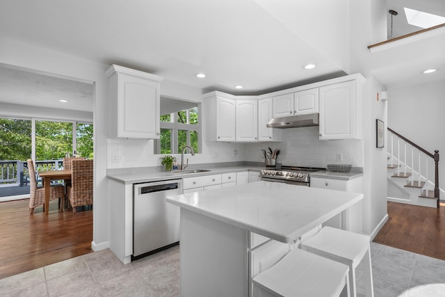 23 Walkerwoods Dr, Harwich, MA 02645 - kitchen with stainless steel appliances, under cabinet range hood, plenty of natural light, light countertops, and recessed lighting