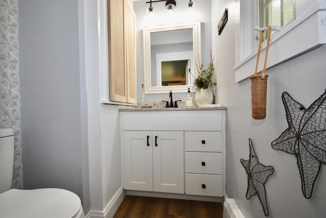 4 Spinnaker Ln, Pocasset, MA 02559 - half bathroom with wood finished floors, vanity, baseboards, and toilet