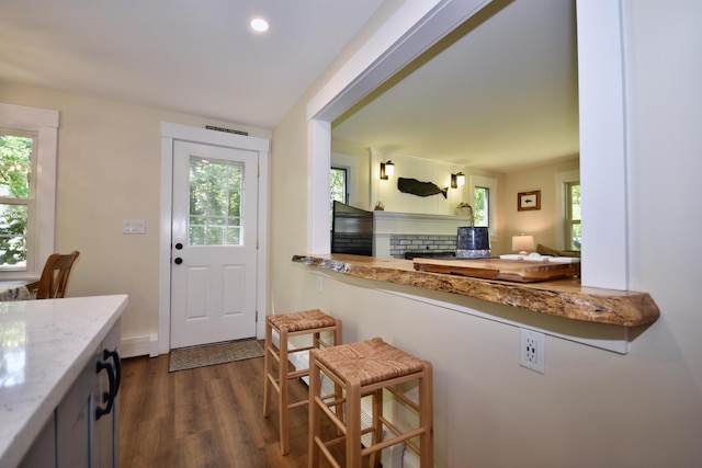 4 Spinnaker Ln, Pocasset, MA 02559 - kitchen with dark wood-style flooring, a fireplace, recessed lighting, and light stone counters