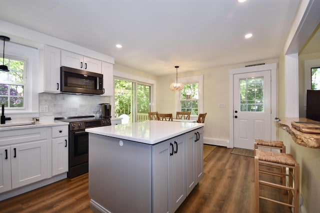 4 Spinnaker Ln, Pocasset, MA 02559 - kitchen with stainless steel microwave, electric range, a sink, dark wood-style floors, and healthy amount of natural light