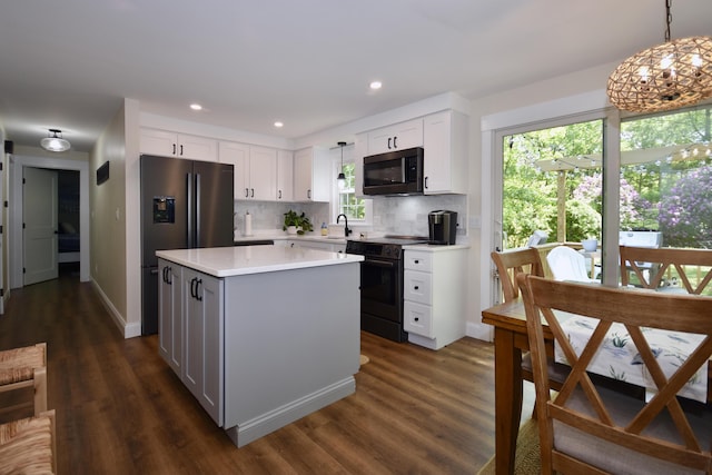 4 Spinnaker Ln, Pocasset, MA 02559 - kitchen with black electric range, light countertops, white cabinetry, tasteful backsplash, and dark wood-type flooring