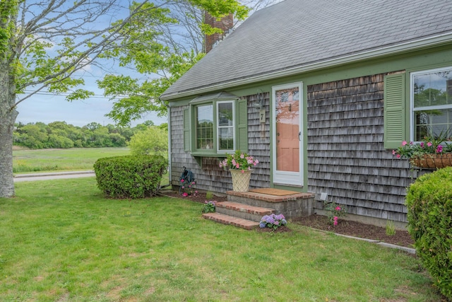 7 George St, Barnstable, MA 02630 - doorway to property featuring a chimney, a yard, and a shingled roof