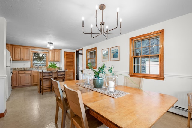 7 George St, Barnstable, MA 02630 - dining space featuring baseboard heating and a chandelier