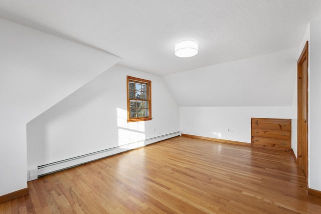 7 George St, Barnstable, MA 02630 - bonus room featuring a baseboard heating unit, wood finished floors, vaulted ceiling, and baseboards
