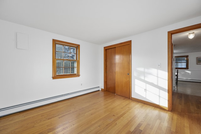7 George St, Barnstable, MA 02630 - empty room featuring a baseboard heating unit, light wood-type flooring, and baseboards