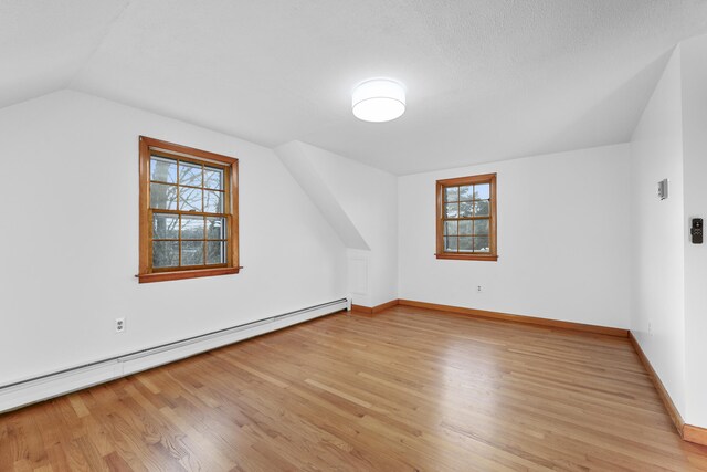 7 George St, Barnstable, MA 02630 - additional living space featuring baseboard heating, lofted ceiling, light wood-type flooring, and plenty of natural light