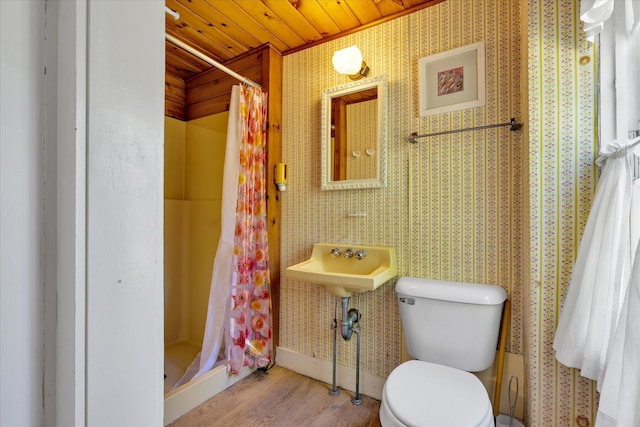 34 Oak St, Harwich, MA 02645 - bathroom with wood ceiling, a shower stall, toilet, wood finished floors, and wallpapered walls