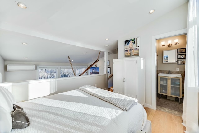 bedroom with lofted ceiling, light hardwood / wood-style flooring, and an AC wall unit