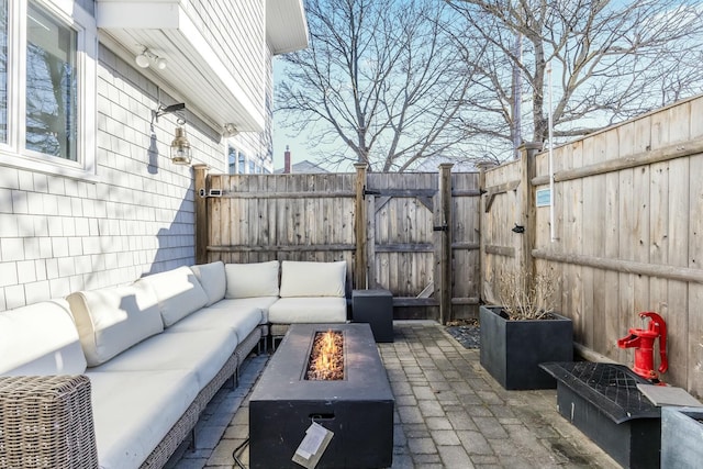 view of patio / terrace with an outdoor living space with a fire pit