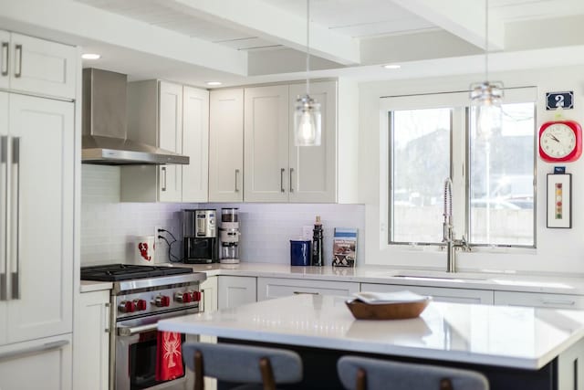 kitchen featuring wall chimney exhaust hood, sink, stainless steel stove, and white cabinets