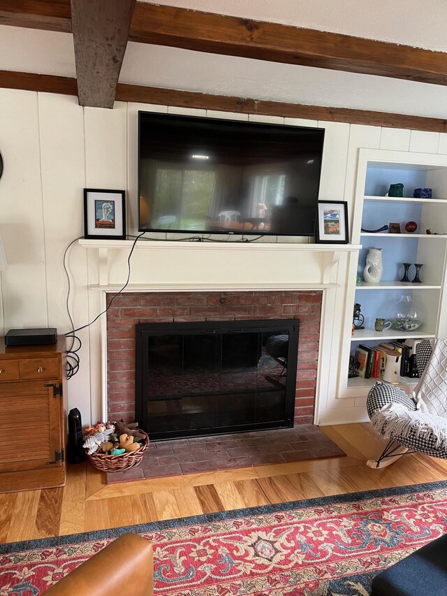 29 Chipman Rd, Sandwich, MA 02563 - details featuring beamed ceiling, wood finished floors, a brick fireplace, and built in shelves
