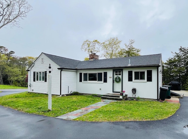 29 Chipman Rd, Sandwich, MA 02563 - view of front of property featuring a chimney, a shingled roof, and a front lawn