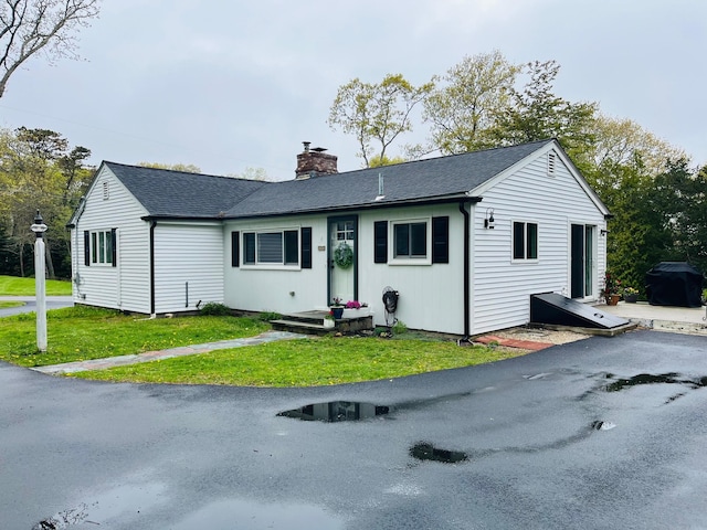 29 Chipman Rd, Sandwich, MA 02563 - ranch-style home with roof with shingles, a front lawn, and a chimney